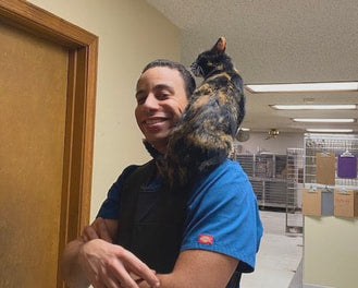 Dr. Zach Coston with cat on shoulder